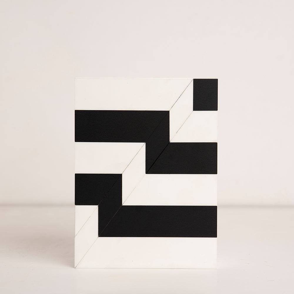 Top-down view of black and white striped birthday gift box in acrylic