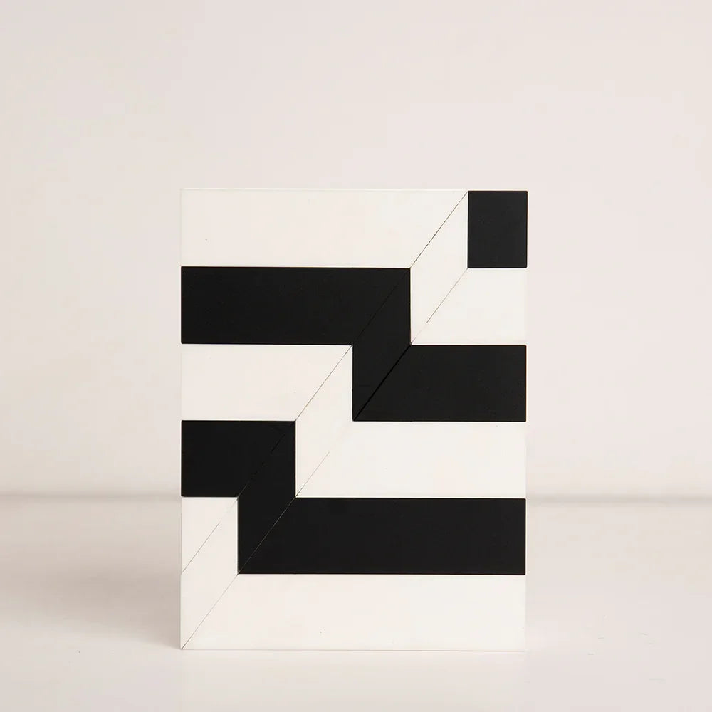 Top-down view of black and white striped birthday gift box in acrylic