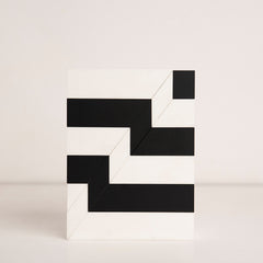 Top-down view of black and white striped birthday gift box in acrylic