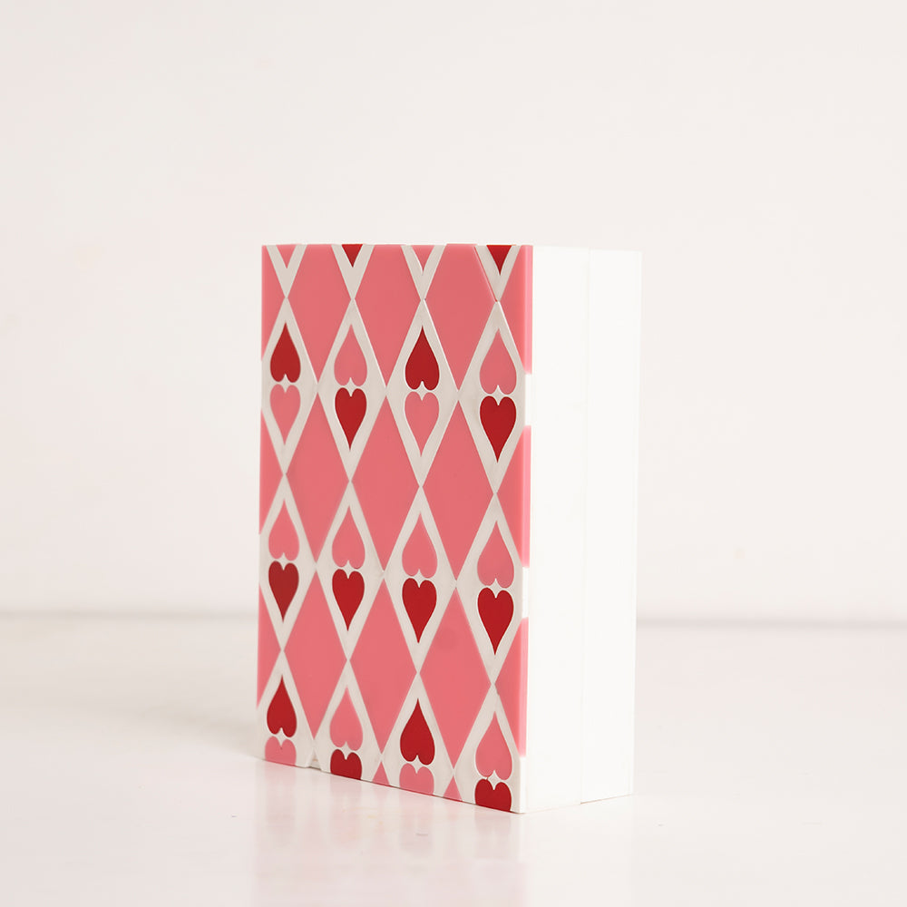 Side perspective showing layered red and pink heart acrylic gift box