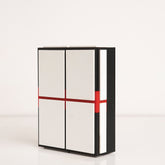 Angled view showing layered design of red, black, and white acrylic gift box