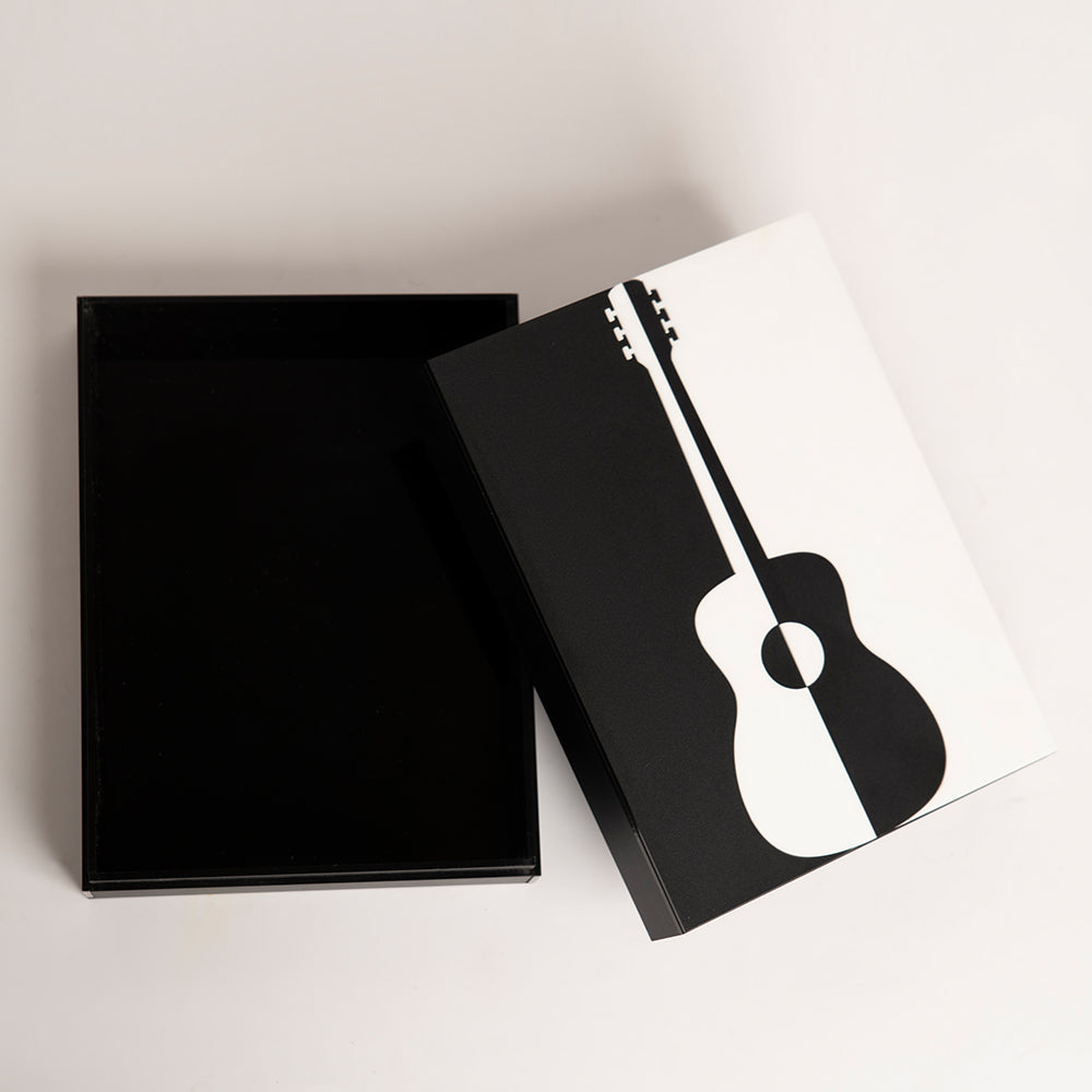 Top view of bold guitar-themed gift box in black and white