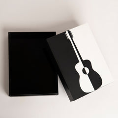 Top view of bold guitar-themed gift box in black and white