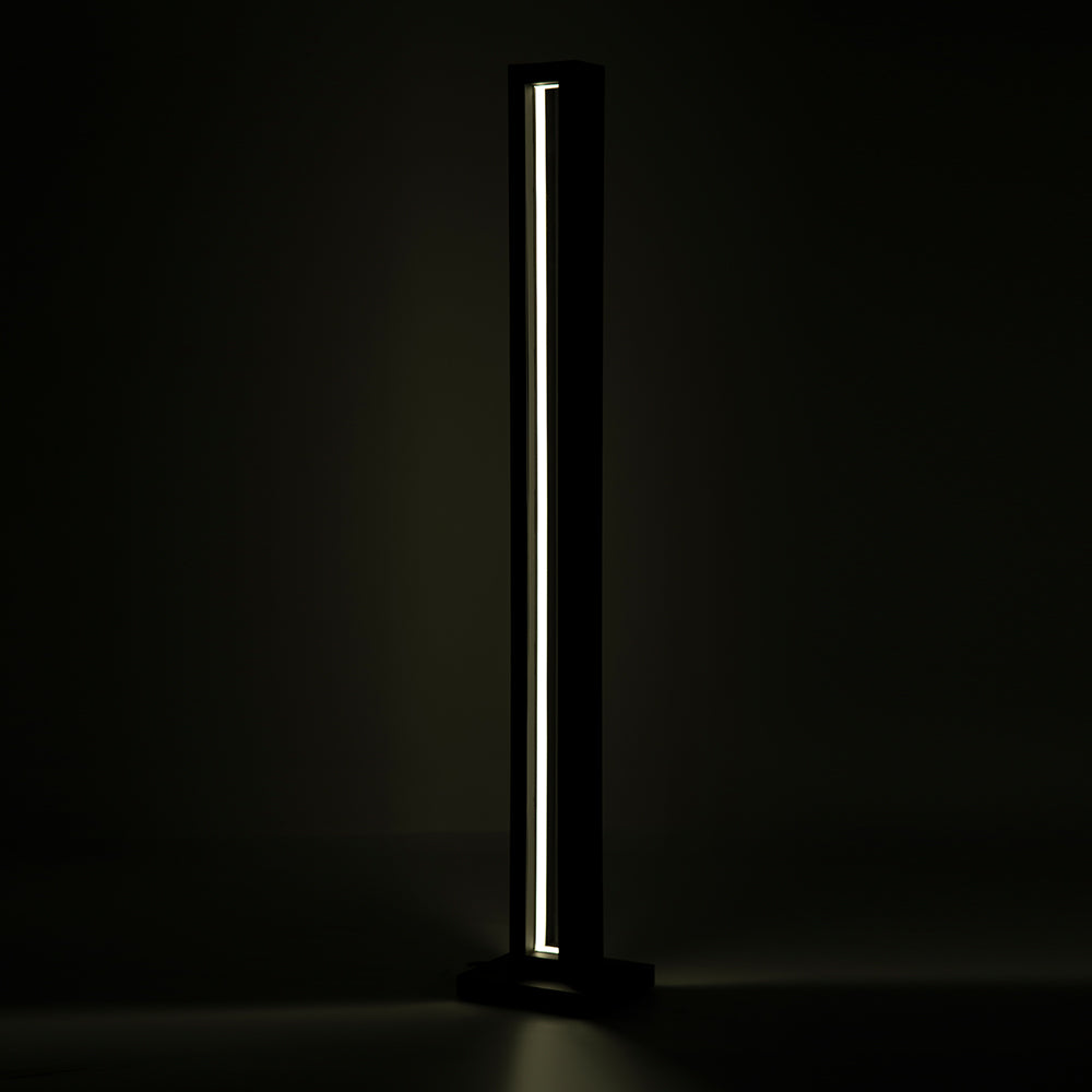 Angled shot highlighting the lamp’s tall structure and glow