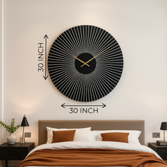 Black wall clock on a white wall above a bed with brown and white bedding.