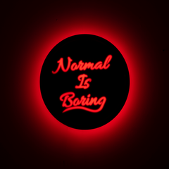 Front shot of wall hanging displaying “Normal Is Boring” text clearly
