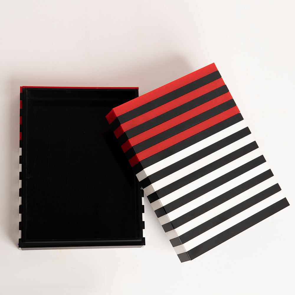 Open view of stylish red, black, and white acrylic box for gifting