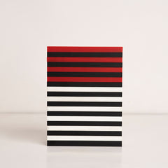 Front view of red, black, and white striped acrylic gift box