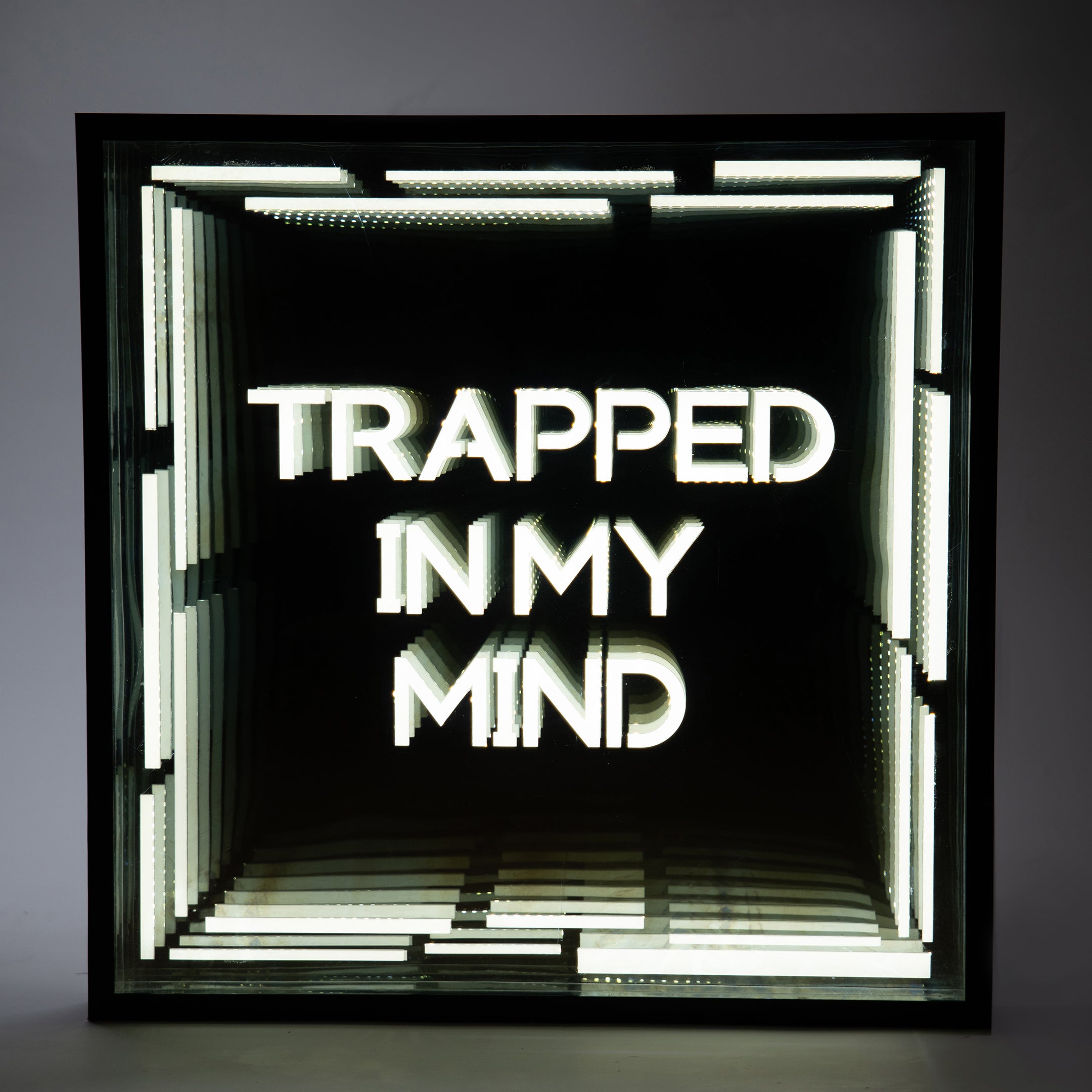 Front shot of Trapped In My Mind Infinity Mirror with deep glowing tunnel