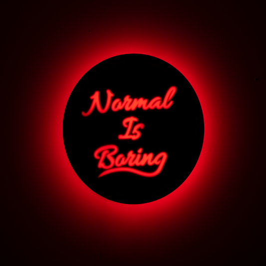 Front shot of wall hanging displaying “Normal Is Boring” text clearly